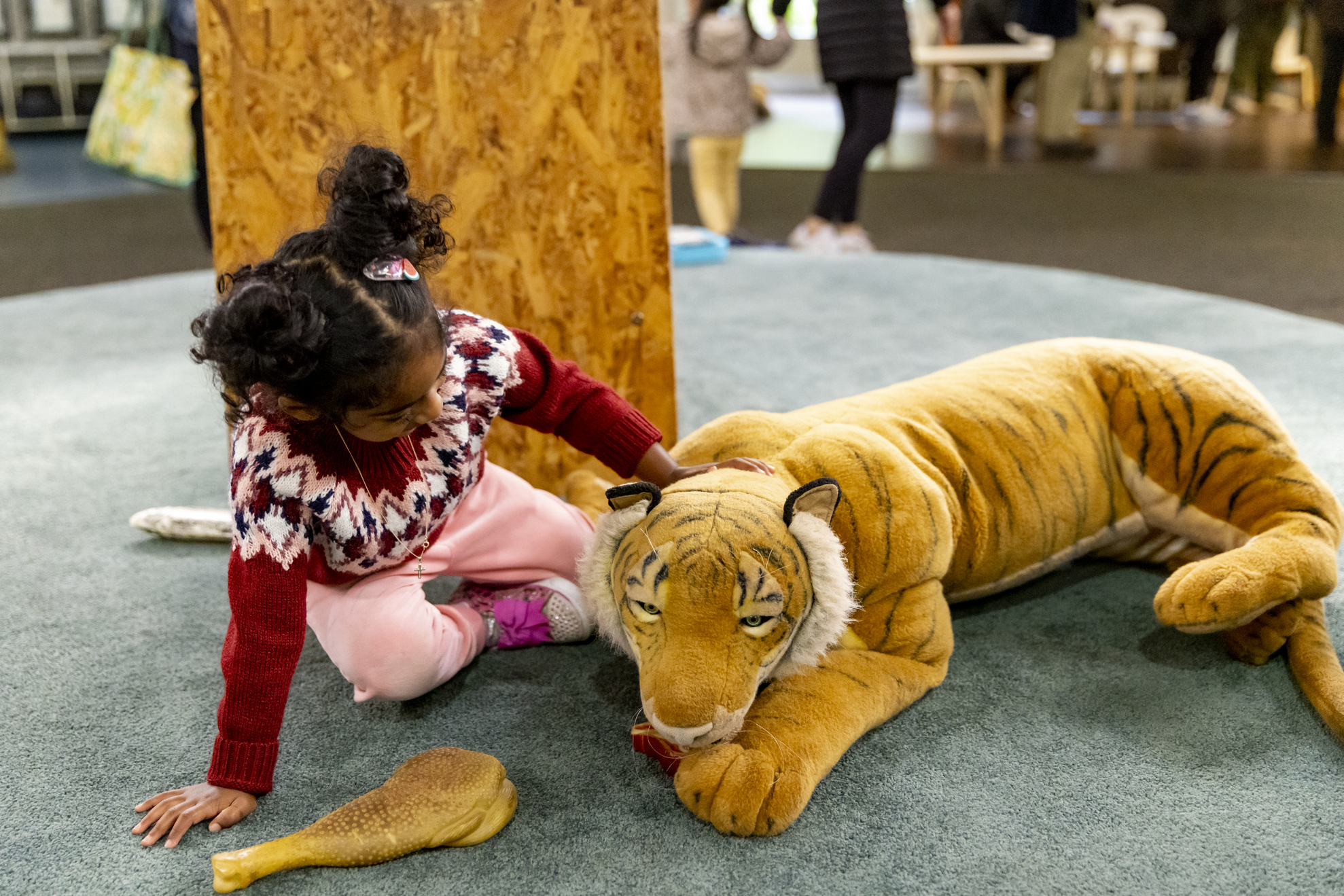 A young guest pets the "Tiger" of Keeper Kids.