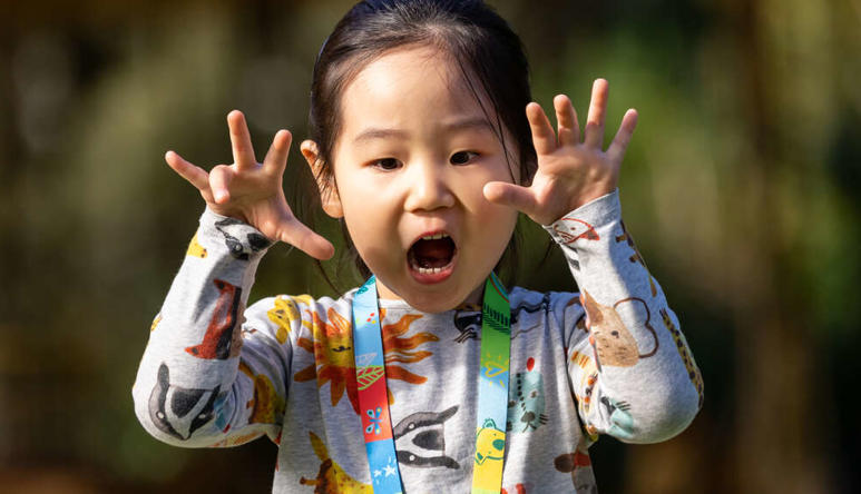 A girl roaring at the camera