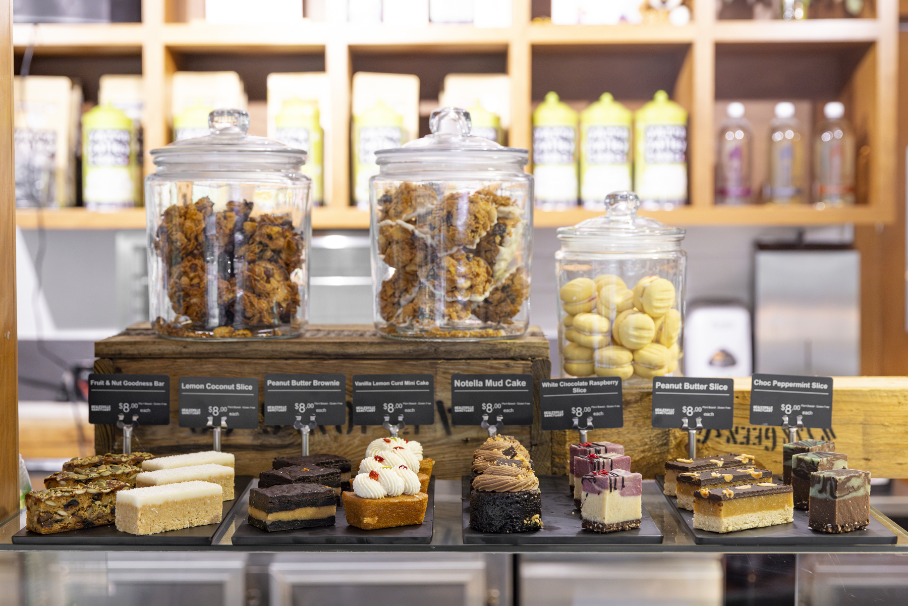 Jars of muffins, cookies and dessert slices on a benchtop in the Sanctuary Harvest Cafe.