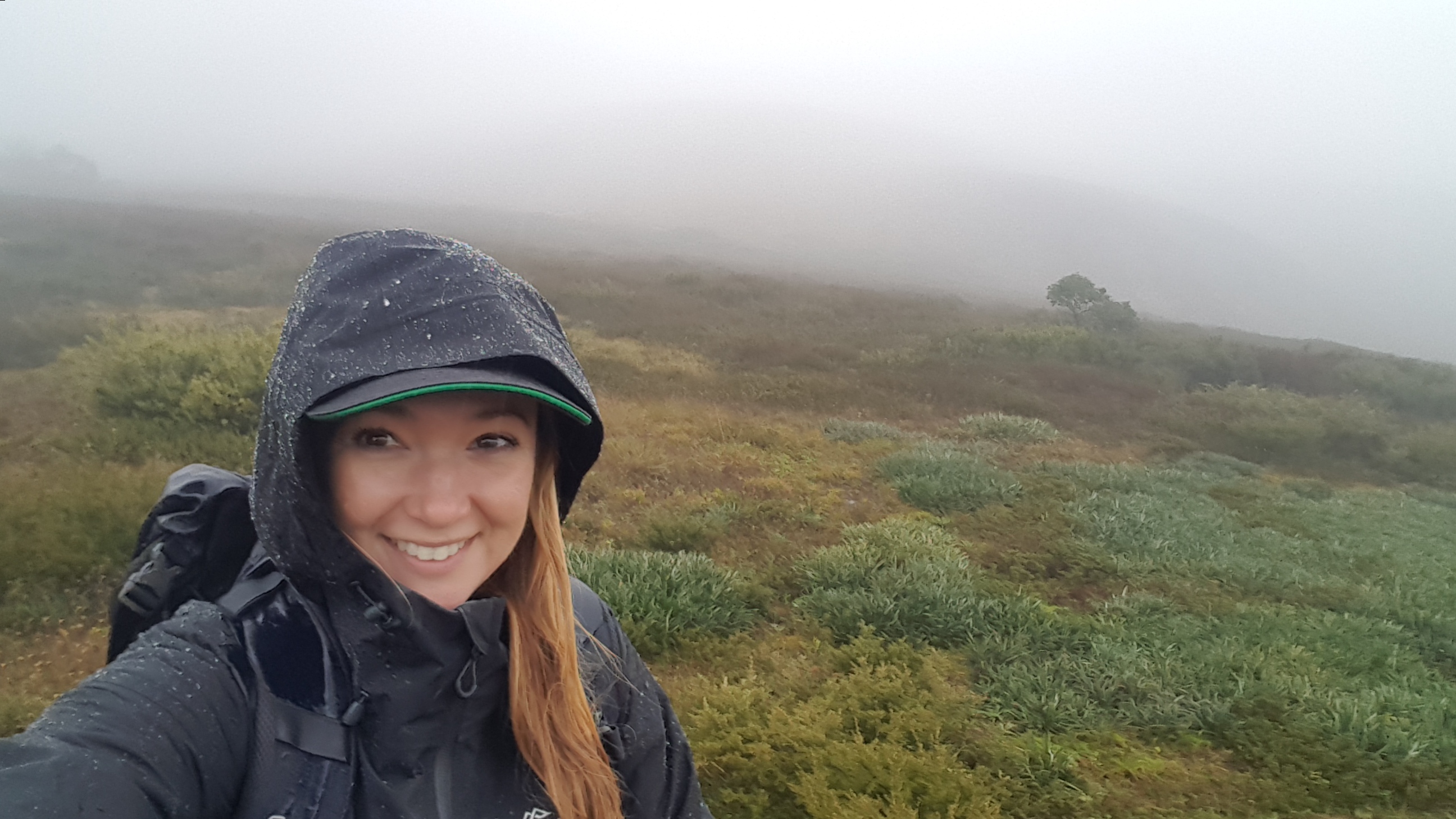 Dr. Marissa taking a "selfie" on a cold foggy plain, smiling in winter wear.